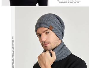 Detail view of dark grey cable-knit winter beanie with leather logo patch and neck gaiter