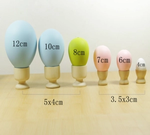 Comparison of various sizes of artificial Easter eggs on minimalist wooden stands