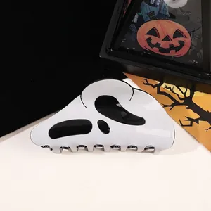 Macro detail of high-gloss white ghost face hair claw clip for Halloween theme