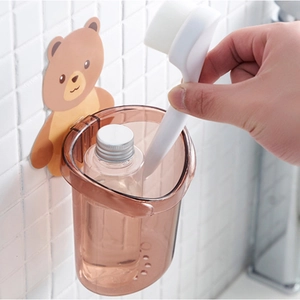 Wall-mounted bear toothbrush holder with brown transparent cup and adhesive back