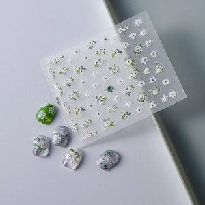Self-adhesive embossed floral nail art stickers with white 3D flowers and green leaves