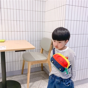 Side view of child wearing a colorful cartoon bus chest bag with Elmo pattern detail