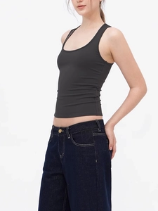 Detail view of the slimming black athletic tank top showing 45-degree fit and fabric texture