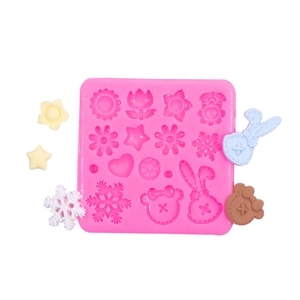 Pink silicone mold featuring snowflake, star, and flower shapes for DIY chocolate and fondant
