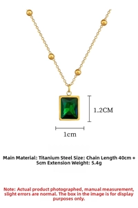Detail view of emerald rectangle pendant on gold titanium steel necklace with dimensions
