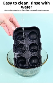 Detail of easy-to-clean black silicone skull ice mold under running water for cleaning