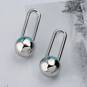 Punk style silver geometric lock and ball metal earrings with a high-shine finish