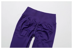 Close-up of seamless dark purple yoga leggings featuring high waist and scrunch butt detail