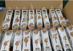 Bulk packaging of Gotham Pancake Bonanza non-stick copper pans in a warehouse storage box