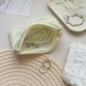 Detail of light green chiffon floral coin pouch used for storing pearl necklaces