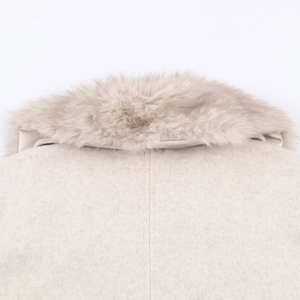 Detail of soft faux fur collar and stitched seam on beige wool coat back