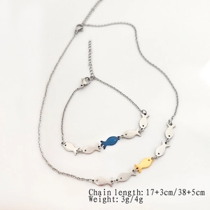 Minimalist silver fish pendant necklace and bracelet set with yellow and blue accents