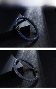 Macro detail of men's braided leather bracelet featuring a black magnetic metal clasp