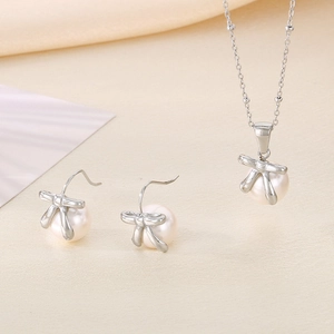 Elegant silver stainless steel bow and pearl jewelry set with necklace and earrings
