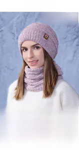Detail of winter knitted hat and neck warmer set with warm fleece lining and logo patch