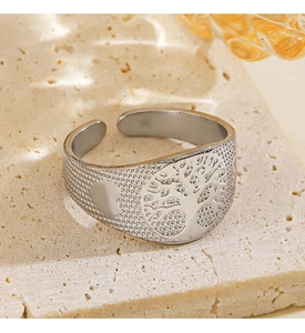Detailed macro view of an adjustable silver Tree of Life ring on a natural stone base