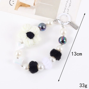 Acrylic heart pearl phone charm with crochet flower and Good Luck metal tag