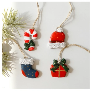 Detailed view of resin Christmas charms including candy cane, sock and gift box items