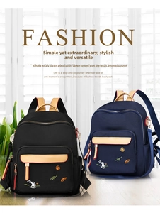 Detail of embroidered rabbit pattern on waterproof nylon fashion backpacks in black and blue