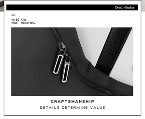 Detailed view of the sleek double metal zippers on this black minimalist nylon crossbody bag