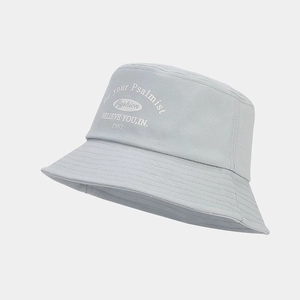 Close-up of light gray bucket hat with white vintage lettering and reinforced stitched brim