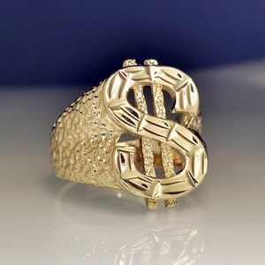 Macro detail of 18k gold plated dollar sign ring with textured hammered band details