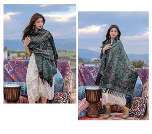 Detailed view of women's ethnic style paisley shawl with tassels in green and blue