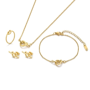 Polished gold knot jewelry set including necklace, bracelet, earrings and ring on white