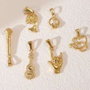 Set of six golden vintage pendants featuring microphone, headphones, guitar, and stethoscope