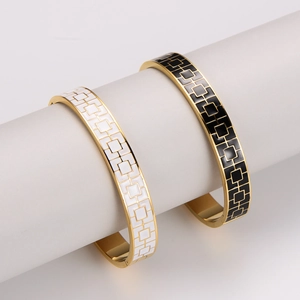 Minimalist enamel gold bangle with geometric patterns in black and white finish