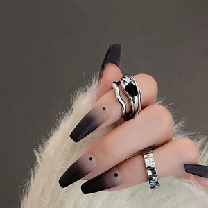 Detail of silver rings featuring a black zircon stone and hammer textured metal finish