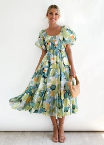 Detail of square neckline and puff sleeves on a green geometric print midi dress