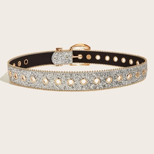 Detail of silver sequin belt with gold metal eyelets and classic pin buckle design