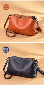 Close-up of leather shoulder bags with three zipper compartments in brown and dark blue