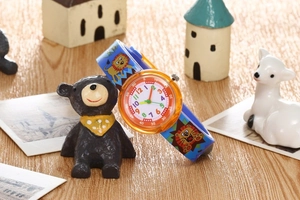 Detailed view of kids blue slap watch with lion patterns and colorful analog dial