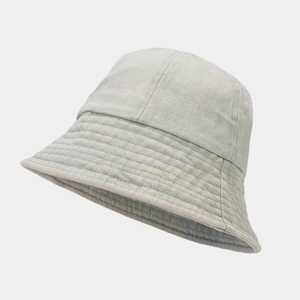 Detail of denim bucket hat featuring fine parallel stitching and high-quality fabric texture