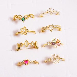 Detail of assorted gold-finish rings with pearls, cubic zirconia and colorful gemstones