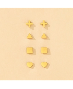 Close-up of four pairs of golden geometric stud earrings including cross and heart shapes