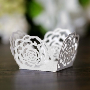 Close-up of laser-cut white paper rose hollow decorative lace for tea light candles
