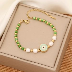 Fashion gold bracelet featuring green beads, white pearls, and an evil eye charm pendant