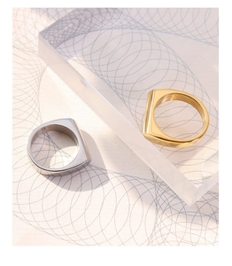 Detailed view of rectangular flat-top geometric rings in gold and silver stainless steel