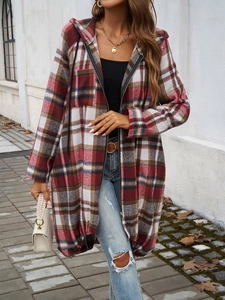 Detail of a red and brown plaid long hooded jacket with zipper closure on a female model