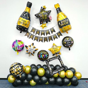 New Year party decoration set with gold black champagne foil balloons and photo frame