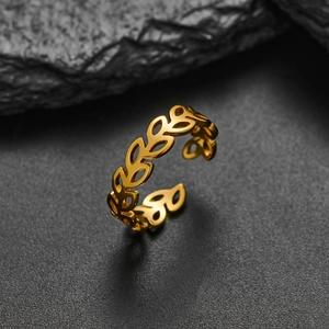 Detail of a gold adjustable leaf ring with an olive branch design on dark stone