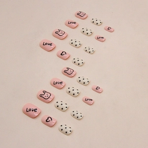 Short square pink and white press-on nails with cute bunny, love letters, and dots