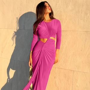 Detail of waist cutout and draped ruched design on this elegant magenta maxi dress