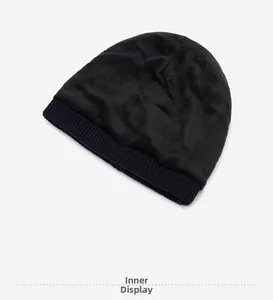 Detailed close-up of the thick thermal fleece lining inside the black knitted beanie cap
