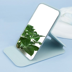 Detail of light blue PU leather folding mirror with adjustable stand for travel