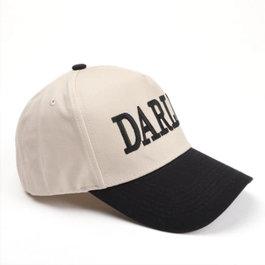 Detail of embroidered 'DARLING' text on a two-tone cotton baseball cap with curved brim