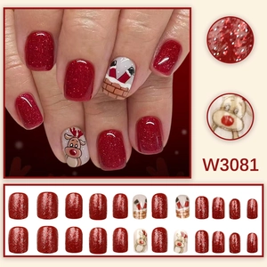 Red Christmas press-on nails featuring reindeer and Santa chimney hand-painted designs